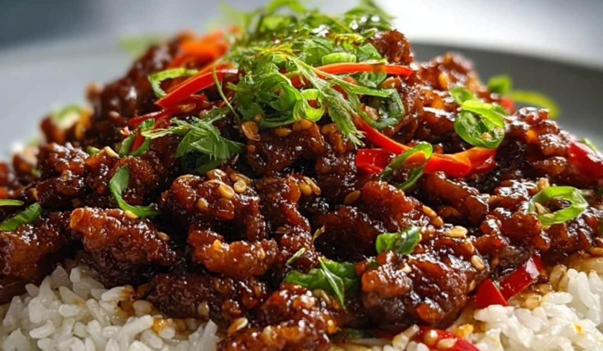 Crispy Chilli Beef Rice served on white rice with sliced chilies and scallions