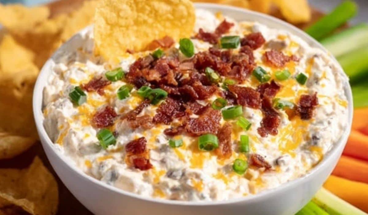 High Protein Crack Dip with bacon and green onions in a white bowl