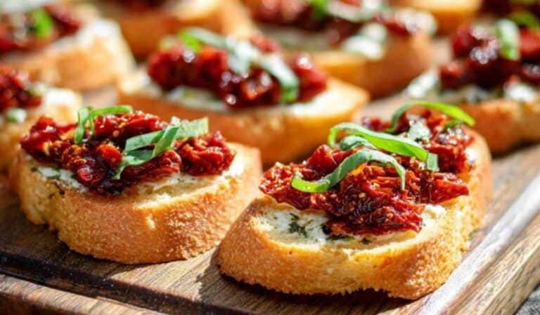 Sun-Dried Tomato Bruschetta on toasted baguette with fresh basil and olive oil