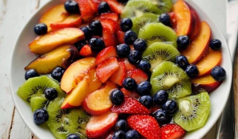 Fruit Salad with Honey Lime Dressing featuring strawberries, kiwi, blueberries, and nectarines