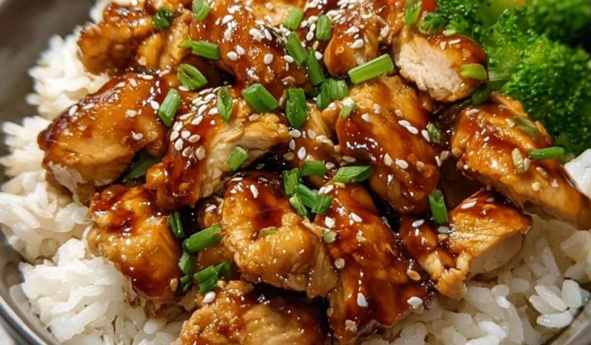 Teriyaki chicken rice bowl with sesame seeds, green onions, and steamed broccoli.