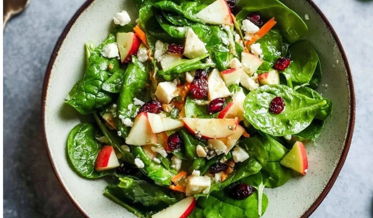 Apple Feta Spinach Salad served in a bowl with cranberries and feta