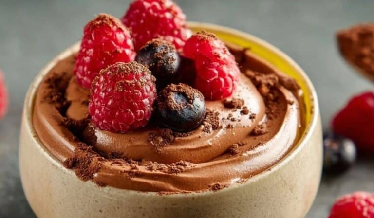 Chocolate Avocado Mousse with raspberries and cocoa dust