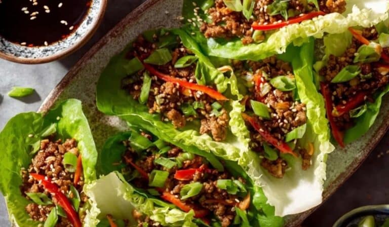 Classic Chinese lettuce wraps served on a platter with hoisin dipping sauce