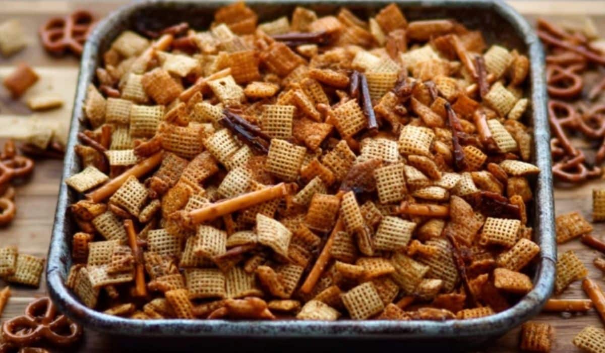 Homemade Chex Mix in a baking tray with pretzels and cereal