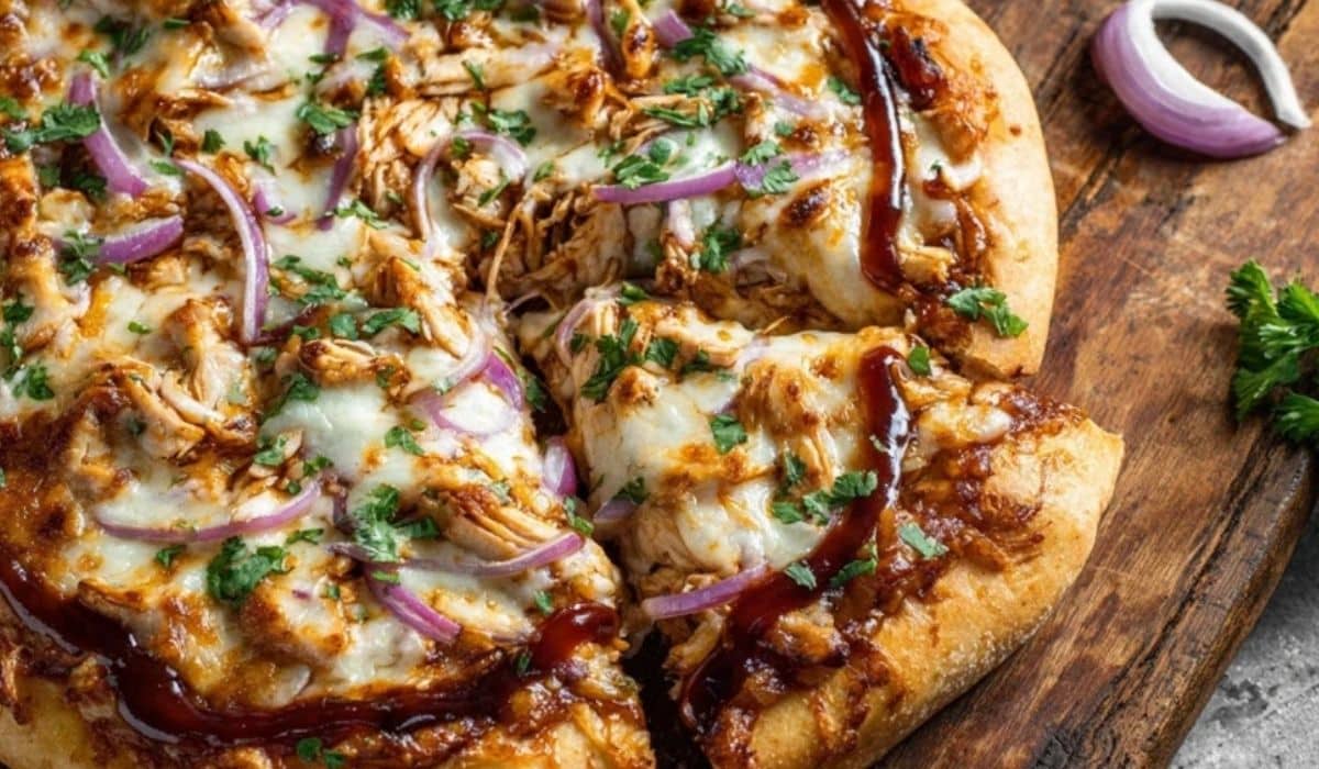 Homemade BBQ Chicken Pizza served sliced on rustic table