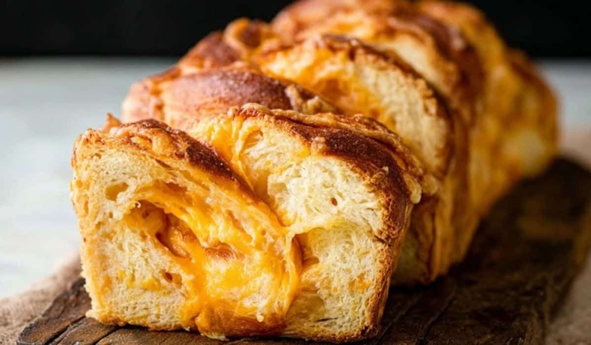 Homemade Cheese Bread – Extra Soft loaf sliced on a wooden board