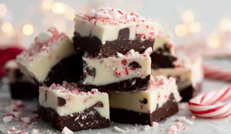 Peppermint Bark Fudge served on a holiday plate with crushed candy canes