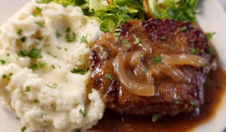 Easy cube steak with onion gravy and mashed potatoes on a plate
