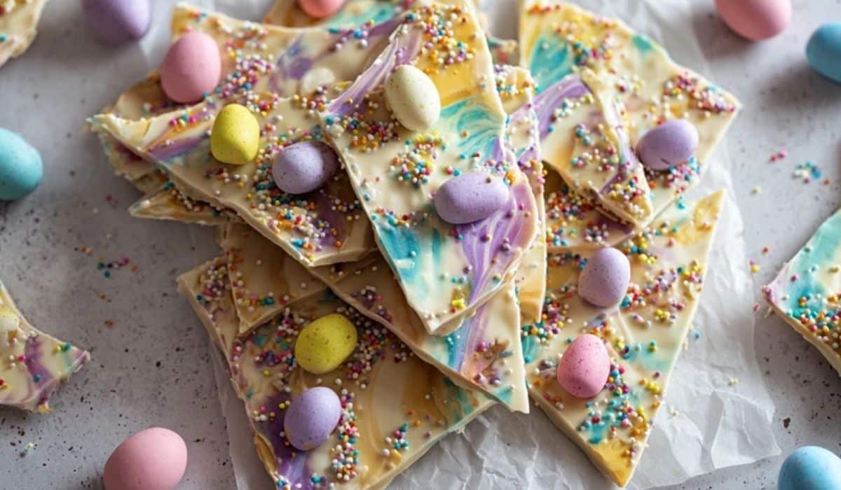 No-bake Easter bark with pastel swirls, mini eggs, and sprinkles on a tray