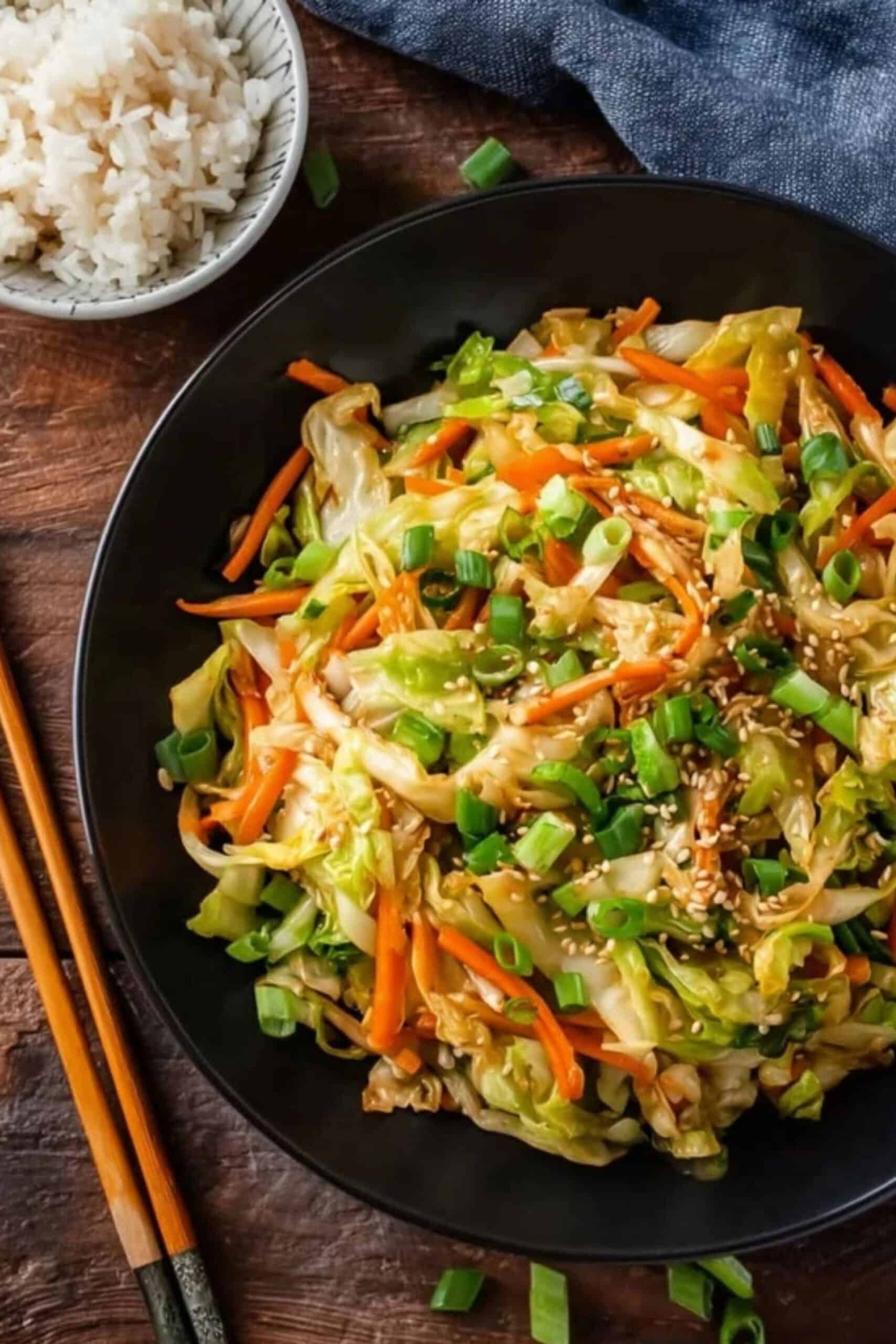 Quick Cabbage Stir Fry in a skillet with carrots and green onions