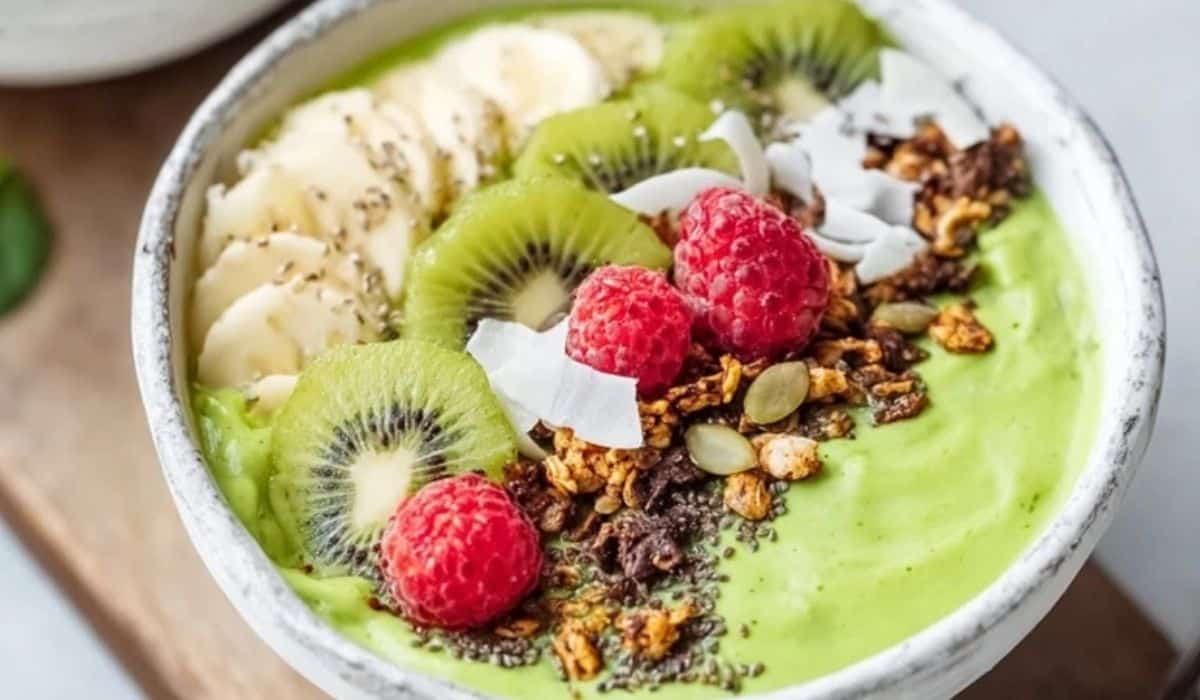 Spring detox green smoothie bowl with fruit and seeds in a white bowl